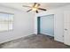 Bright bedroom with gray carpet, a ceiling fan, and a small closet at 14646 Coronado Dr, Spring Hill, FL 34609