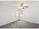 Bright, spacious bedroom with gray carpet, dual windows, and a ceiling fan at 14646 Coronado Dr, Spring Hill, FL 34609