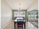 Bright dining area with large windows and sliding glass doors leading to an outdoor space at 14646 Coronado Dr, Spring Hill, FL 34609