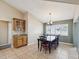 Dining room features tile floor, large window and charming wood table with seating for six at 14646 Coronado Dr, Spring Hill, FL 34609