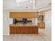 Open-concept kitchen with wood breakfast bar, stainless sink, and seamlessly connected to dining and living areas at 14646 Coronado Dr, Spring Hill, FL 34609