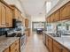 Well-lit kitchen with granite countertops, stainless steel appliances, and lots of counter space at 14646 Coronado Dr, Spring Hill, FL 34609
