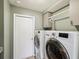 Laundry room featuring modern washer and dryer, utility sink, and storage cabinets at 14646 Coronado Dr, Spring Hill, FL 34609