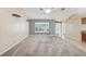 Open living room with large windows, neutral walls, and carpet flooring at 14646 Coronado Dr, Spring Hill, FL 34609