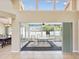 View of screened porch with outdoor seating and bright natural lighting from the home's interior at 14646 Coronado Dr, Spring Hill, FL 34609