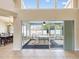 View of screened porch with outdoor seating and bright natural lighting from the home's interior at 14646 Coronado Dr, Spring Hill, FL 34609