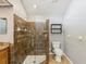 Bathroom featuring a glass shower with tiled walls, a vanity, and toilet at 14646 Coronado Dr, Spring Hill, FL 34609