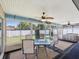 Relaxing sunroom with lots of windows, a ceiling fan, and a view to the fenced backyard at 14646 Coronado Dr, Spring Hill, FL 34609