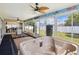 Bright sunroom featuring a hot tub, ceiling fans, and large windows with a view of the backyard at 14646 Coronado Dr, Spring Hill, FL 34609