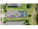 Birds-eye view of a private backyard with a screened pool, overlooking mature trees and a peaceful pond at 1783 Oak Hammock Ct, Lutz, FL 33558