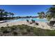 Relaxing community pool with lounge chairs, water features, and beautiful views of the surrounding lake at 1783 Oak Hammock Ct, Lutz, FL 33558