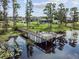 Scenic wooden dock and platform providing access to the calm lake waters and views of the community at 1783 Oak Hammock Ct, Lutz, FL 33558