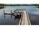 Scenic wooden dock and platform providing access to the calm lake waters for fishing or relaxation at 1783 Oak Hammock Ct, Lutz, FL 33558