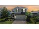 Charming two-story home featuring a well-manicured lawn, brick-paved driveway, and attached two-car garage at 1783 Oak Hammock Ct, Lutz, FL 33558