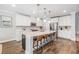 Bright kitchen featuring a spacious island with bar stools, modern cabinetry, and stainless steel appliances at 1783 Oak Hammock Ct, Lutz, FL 33558