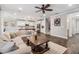 Open-concept living room showcases wood-look tile floors, comfortable seating, and a seamless flow into the modern kitchen at 1783 Oak Hammock Ct, Lutz, FL 33558