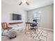 Bright office space with a modern desk, stylish chair, floating shelf, and a patterned rug at 1783 Oak Hammock Ct, Lutz, FL 33558