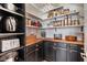 Well-organized pantry features wood countertops, black cabinets, and ample shelving for storage at 1783 Oak Hammock Ct, Lutz, FL 33558