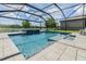 Beautiful screened-in pool offers a refreshing retreat with a serene lake backdrop at 1783 Oak Hammock Ct, Lutz, FL 33558