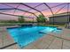 Stunning screened-in pool area with a lake view, perfect for outdoor relaxation and entertaining at 1783 Oak Hammock Ct, Lutz, FL 33558