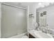 Well-lit bathroom with a granite vanity, framed mirror, and a shower featuring sliding glass doors at 18530 Dobson Dr, Hudson, FL 34667
