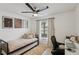 Bright bedroom features twin trundle bed, ceiling fan, artwork, and desk providing a versatile space at 18530 Dobson Dr, Hudson, FL 34667