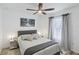 Cozy bedroom features a comfortable bed, stylish lamps, curtains, and a ceiling fan for enhanced comfort at 18530 Dobson Dr, Hudson, FL 34667