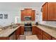 Functional kitchen with stainless steel appliances, granite counters, tile floors, and lots of storage at 18530 Dobson Dr, Hudson, FL 34667