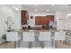 Spacious kitchen featuring granite countertops, a breakfast bar with white stools, and stainless steel appliances at 18530 Dobson Dr, Hudson, FL 34667
