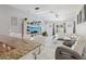 Open-concept living room with a modern entertainment center, stylish furniture, and a cozy atmosphere at 18530 Dobson Dr, Hudson, FL 34667