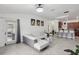 Stylish living room with a modern sectional sofa, tile floors, and an open layout connecting to the kitchen at 18530 Dobson Dr, Hudson, FL 34667