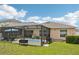 Screened pool enclosure with a lovely backyard, ideal for relaxing or entertaining at 18530 Dobson Dr, Hudson, FL 34667