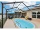 The screened enclosure features a lovely pool with a variety of outdoor seating at 18530 Dobson Dr, Hudson, FL 34667