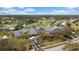 Aerial view of a clubhouse featuring ample parking, putting green, and a lush golf course at 18736 Bent Pine Dr, Hudson, FL 34667