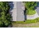 Bird's eye view of a well maintained home with lush landscaping, mature trees, and an extended driveway at 18736 Bent Pine Dr, Hudson, FL 34667