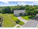 An aerial view of a landscaped lawn, well-maintained home, and serene suburban neighborhood at 18736 Bent Pine Dr, Hudson, FL 34667
