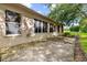 This home has a concrete patio perfect for outdoor seating with mature trees creating a serene backdrop at 18736 Bent Pine Dr, Hudson, FL 34667