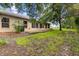 Property featuring a concrete patio perfect for outdoor seating surrounded by a lush backyard at 18736 Bent Pine Dr, Hudson, FL 34667