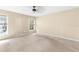 Empty bedroom with carpeted floors and light walls, with natural light coming in through two windows at 18736 Bent Pine Dr, Hudson, FL 34667