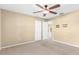 This is a carpeted bedroom with neutral walls, a ceiling fan, and a closet at 18736 Bent Pine Dr, Hudson, FL 34667
