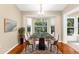 Bright dining room features a modern chandelier and large windows providing natural light and backyard views at 18736 Bent Pine Dr, Hudson, FL 34667