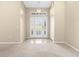 Bright foyer featuring neutral walls, tile flooring, with a decorative glass front door and chandelier at 18736 Bent Pine Dr, Hudson, FL 34667