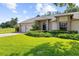 Charming home featuring a manicured lawn, complemented by lush landscaping and a two car garage at 18736 Bent Pine Dr, Hudson, FL 34667