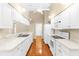 Bright kitchen with white cabinetry, appliances and tiled floor at 18736 Bent Pine Dr, Hudson, FL 34667