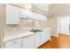 Bright kitchen featuring white cabinets, stainless steel sink, and ample counter space at 18736 Bent Pine Dr, Hudson, FL 34667