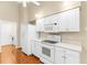 Bright, traditional kitchen area with white appliances and lots of cabinet space at 18736 Bent Pine Dr, Hudson, FL 34667