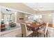 Spacious living area features carpet and tile flooring with seamless transition to the dining space at 18736 Bent Pine Dr, Hudson, FL 34667