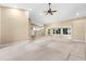 Open-concept living room offers lots of natural light, and a vaulted ceiling with fan at 18736 Bent Pine Dr, Hudson, FL 34667