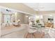Open living room features light-filled interior with a round table and multiple entrances to other areas at 18736 Bent Pine Dr, Hudson, FL 34667