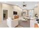 Bright living room with vaulted ceiling, ceiling fan, and neutral decor at 18736 Bent Pine Dr, Hudson, FL 34667